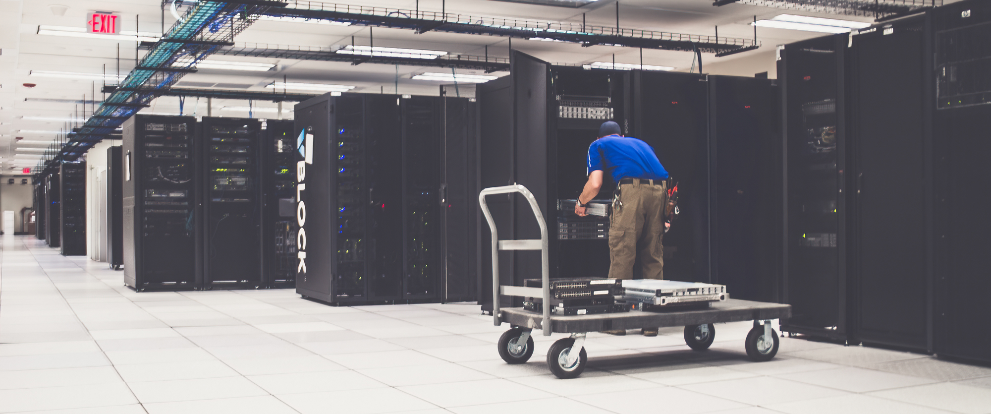 Enterprise server rack migration and asset harvesting inside a large scale data center facility.