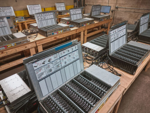 Secure testing and diagnostics lab facility processing rows of enterprise hard drive arrays and blade servers for IT asset recovery.