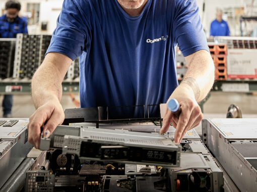 ITAD technician disassembly technician hardware auditing an open enterprise server on a processing conveyor line.